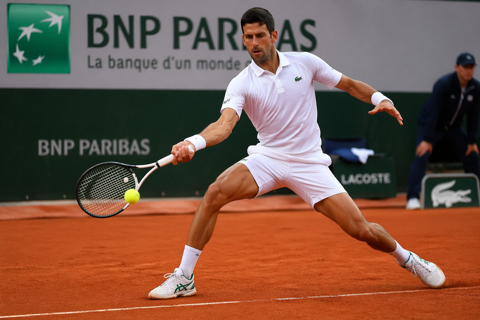A tennis player in action on a soft court surface